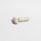 Two beige Alpha energy capsules on a light gray background