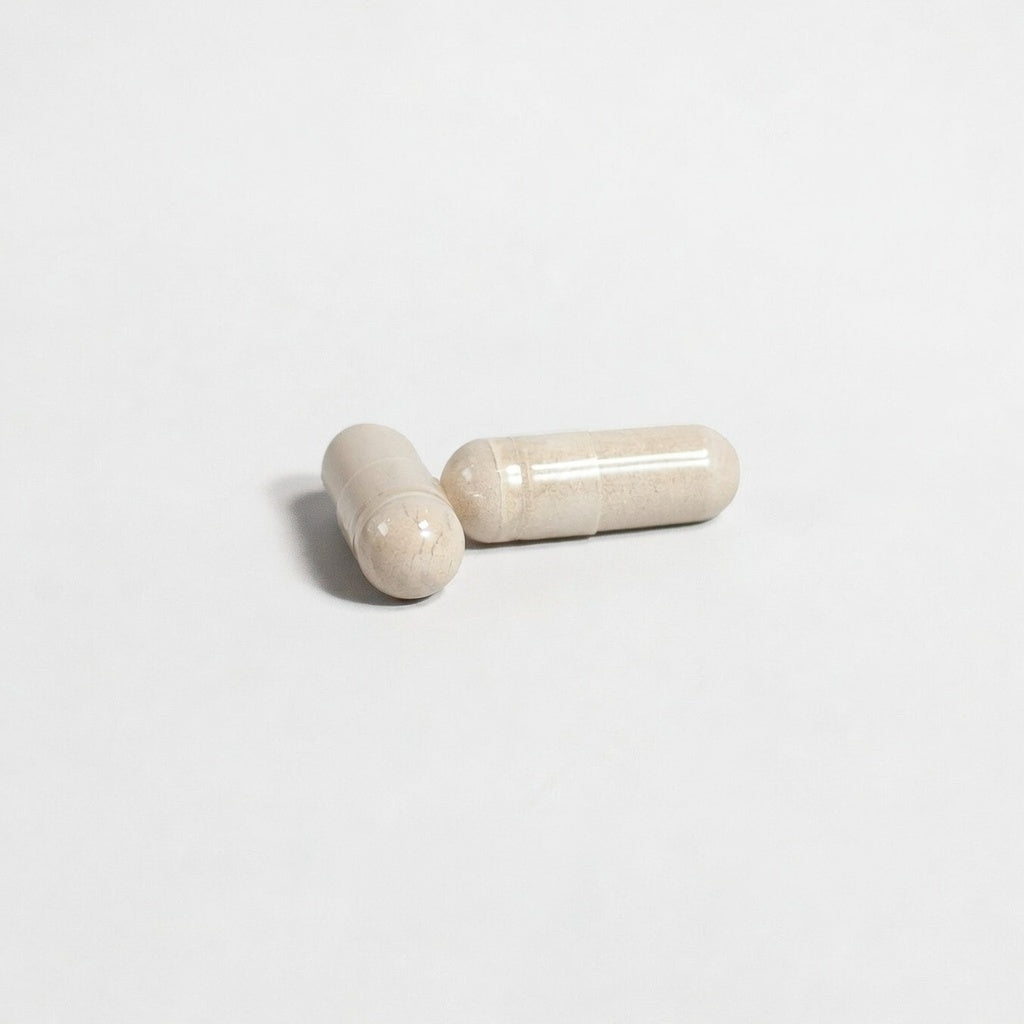 Two beige Alpha energy capsules on a light gray background