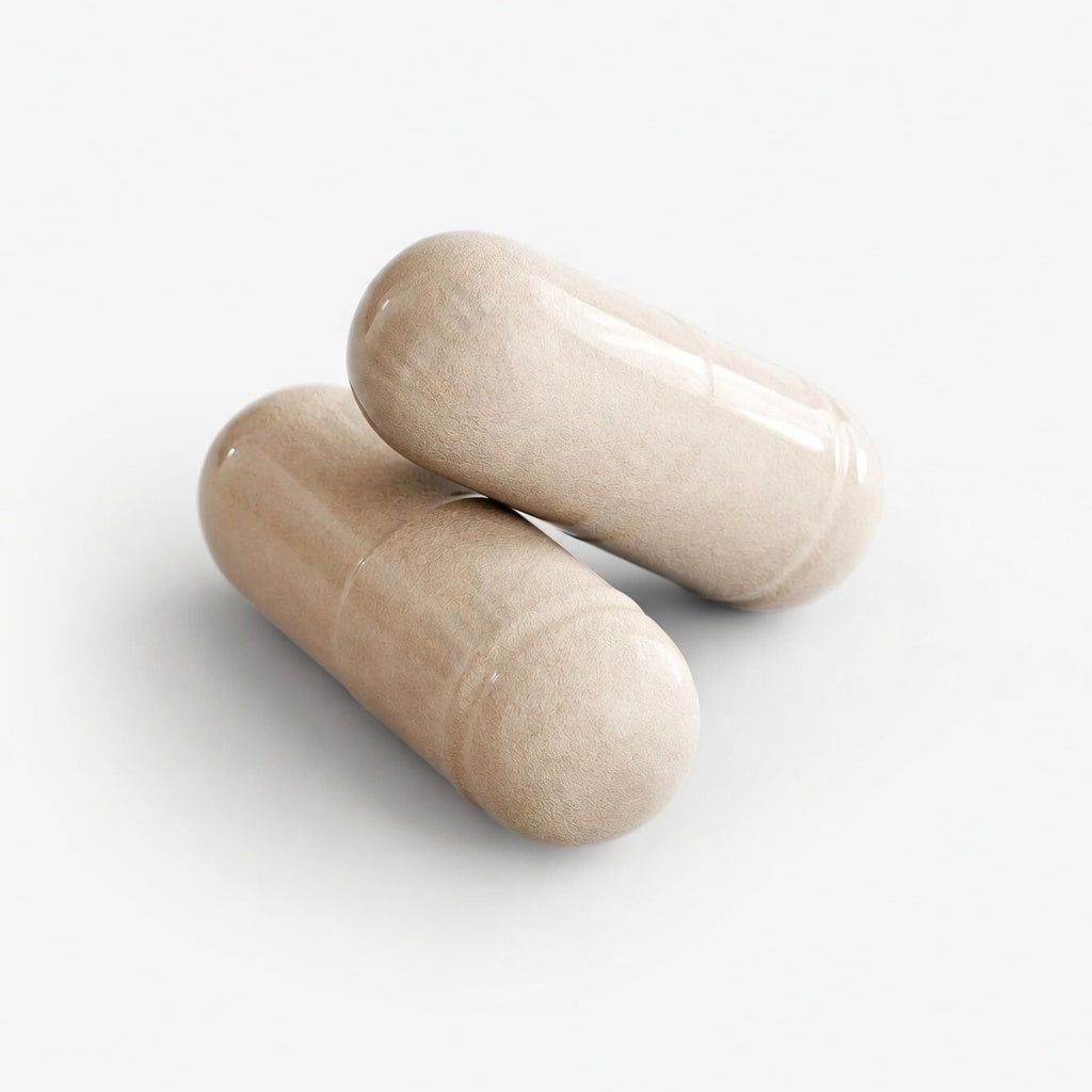 Two beige brain and focus formula capsules on a white background