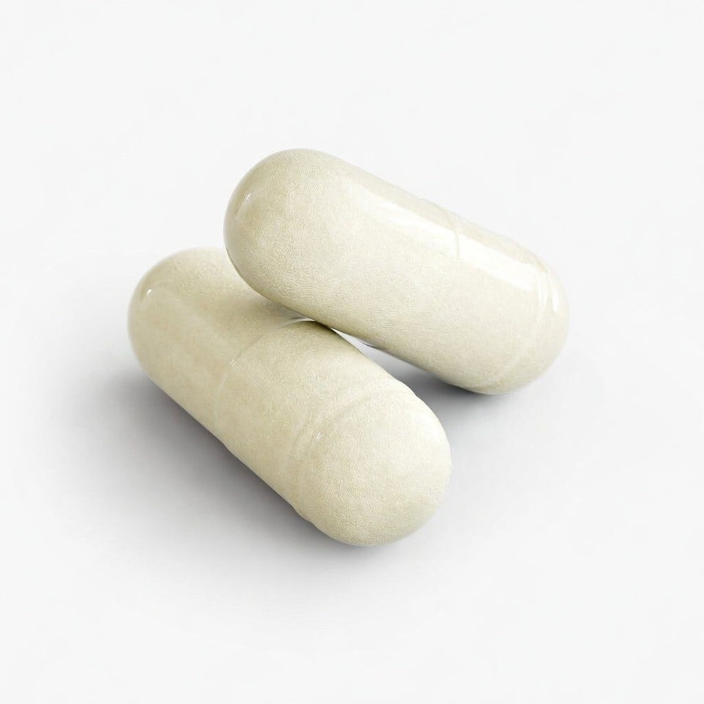Two white digestive enzyme capsules on a light gray background